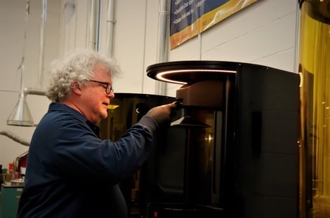 The Technology House team member using a 3D printing machine to create a prototype